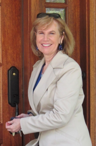 Alice V. McKenna at wooden door, upper body.